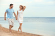 © New Africa - Happy romantic couple running together on beach, space for text