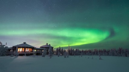 northern lights also known as aurora borealis showing as green movement in the starry nightsky over 