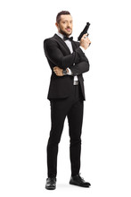 Man In A Suit Holding A Gun