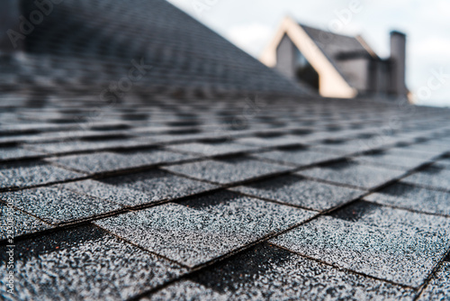 Fotografía selective focus of grey shingles on rooftop of building