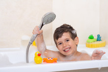 Kid Taking Bubble Bath. Child Bathing In Bathtub. Little Boy Playing With Water. Rubber Duck In Foam Bath. 