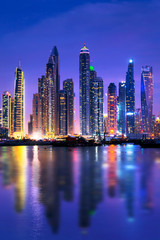 Wall Mural - Dubai marina skyline at night with water reflections, United Arab Emirates