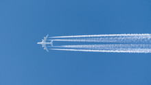 Four-engined Jet Aircraft, Jet Airbus A380 Airplane In The Sky With Condensation Stripes
