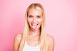 Closeup photo of amazing lady sticking tongue out of mouth teasing boys on street wear white tank-top isolated pink color background