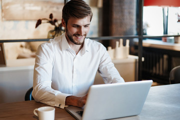 Handsome businessman working with laptop in office