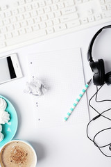 Wall Mural - workspace with notebook, phone, coffe and headphones on white background. Flat lay, top view office table desk