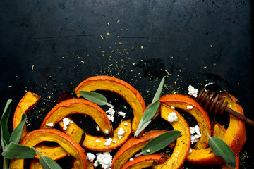 Wall Mural - Baked pumpkin slices with honey, sage and ricotta. Top view with copy space.