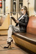 © ppvector - Business woman in a subway car reads a book. Beautiful girl in sunglasses and a jacket in a subway car. Fashionable and stylish girl. Success concept