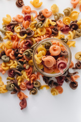 Wall Mural - Pile of bright uncooked macaroni in glass jar