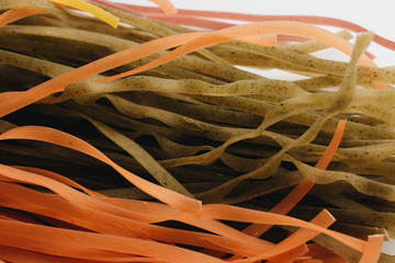 Wall Mural - Pile of bright uncooked macaroni on white background 