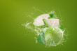 Water splashing on Green guava fruit over green background