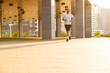© opolja - Attractive fit man running in the city at sunset. Fitness, workout, sport, lifestyle concept
