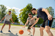 sport, leisure games and male friendship concept - group of men or friends playing street basketball