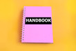 Pink handbook with yellow background
