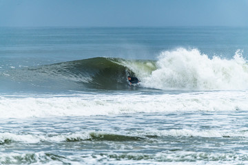 Bodyboarder surfing ocean wave