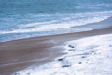 Wall Mural - snow covered beach during a snow storm in daylight