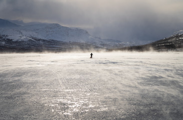 Fototapete - Cross country skier with sled on a frozen river in Lapland. National Park Sarek, Sweden.