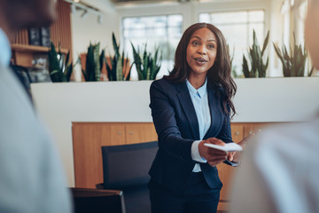 African American concierge helping guests check into her hotel