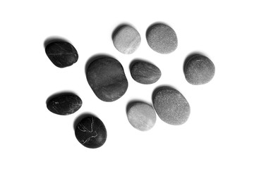 Wall Mural - Sea pebbles. Heap of smooth gray and black stones isolated on white background, top view