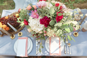 stylish table with fruits and flowers for a holiday on the outdo