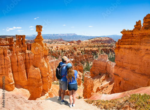 Fotomural Couple on top of the mountain looking at beautiful summer landscape Friends enjoying time together on hiking trip