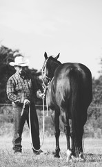 Poster - western lifestyle shows cowboy with horse in black and white.