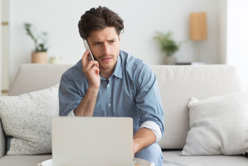 Poster - Guy Having Unpleasant Phone Conversation Working On Laptop At Home