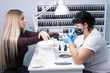 © Евгения Медведева - Master applies varnish drawing on nails gel in manicure salon