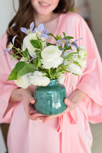 Girl In A Silk Robe Holding A Wedding Bouquet In Vase
