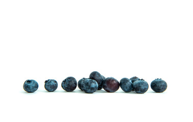 Blue berries on a white background. The concept of eating and eating meals. Eating forest fruit, providing vitamins.