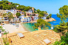 View Of Beach In Sa Tuna Fishing Village With Colorful Houses On Shore, Costa Brava, Catalonia, Spain