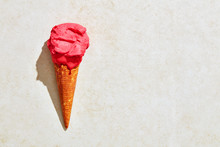 Fresh Strawberry Ice Cream In Waffle Cone With Hot Summer Light