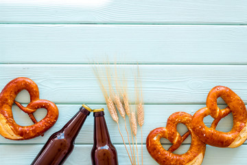 Wall Mural - Beer festival Octoberfest. Pretzels and beer on blue wooden background top view copy space frame