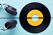Vinyl Record And A Headphone On Blue Wooden Background