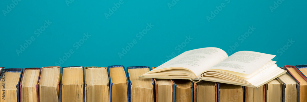 Open book, hardback books on wooden table. Back to school. Copy space - obrazy, fototapety, plakaty 