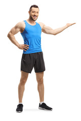 Canvas Print - Young muscular man in sportswear showing with his hand