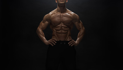 Fitness model man posing in studio