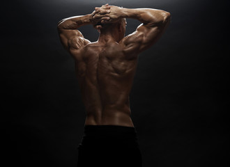 Fitness model man posing in studio