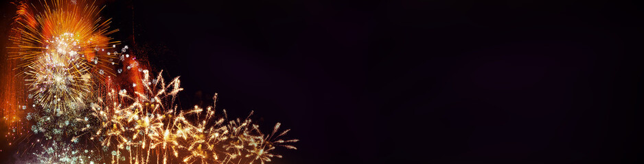 Wall Mural - fireworks with black background and space for text