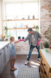 © zinkevych - Father and daughter having much fun while cleaning kitchen