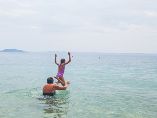 Wall Mural - Child jumping in the sea