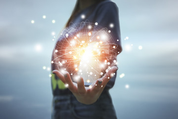 Close up of business woman hands showing digital planet technology.