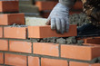 Brick wall contruction with mason hands
