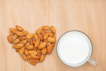 Cup of almond milk on almond nut,top view