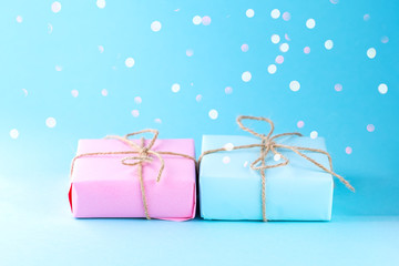 Sticker - Two gift boxes of pink and blue on a blue background, minimalism photography. Place for text.