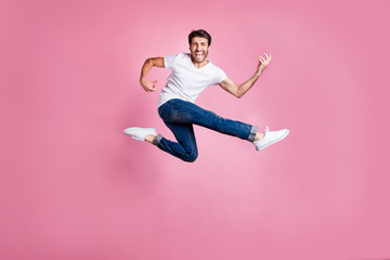 Wall Mural - Full body photo of cheerful funny funky middle eastern man heavy metal lover jump have fun spring events weekends play guitar sing song wear style clothes sneakers isolated pink color background