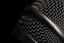 Close-up Black Microphone Head Isolated On Black Background.