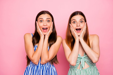 Sticker - Portrait of impressed girls touching their face with hands shouting wearing striped dress skirt isolated over pink background