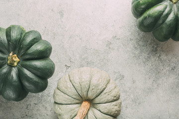 Wall Mural - different pumpkins on wooden surface with copy space.