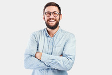 Friendly Face Portrait Of An Authentic Caucasian Bearded Man With Glasses Of Toothy Smiling Dressed Casual Against A White Wall Isolated